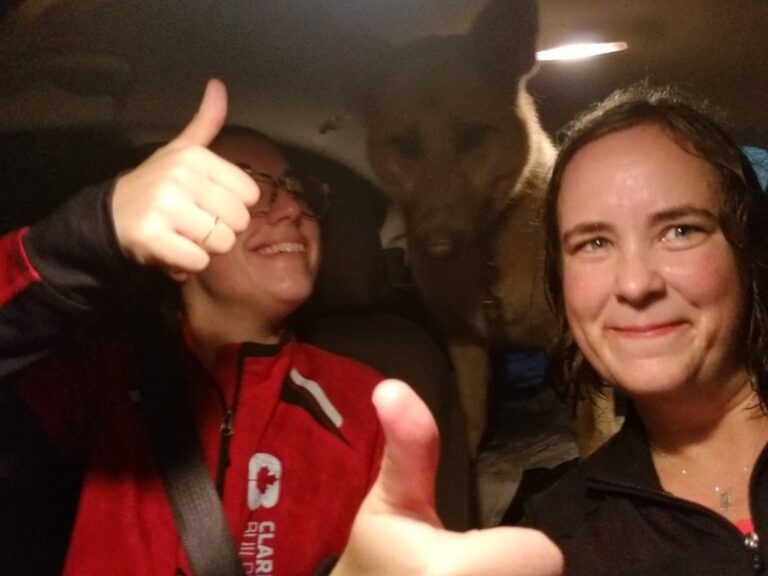 Two wet girls giving thumbs up after running in the rain